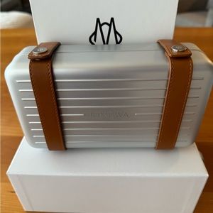 Brand new, never used, tags on, RIMOWA Cross Body Bag in Silver. 5”x 8.5” x 2.5”